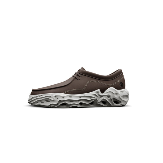 A brown casual shoe with a unique gray sole, designed for comfort and style.