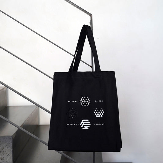 Flowers for Society OG logos jute bag black front view hanging on stair railing