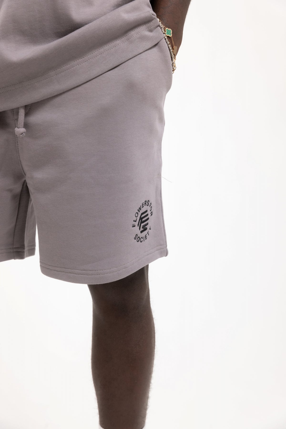 Flowers for Society King Saladeen shorts collaboration King Saladeen dove frontview worn by model standing